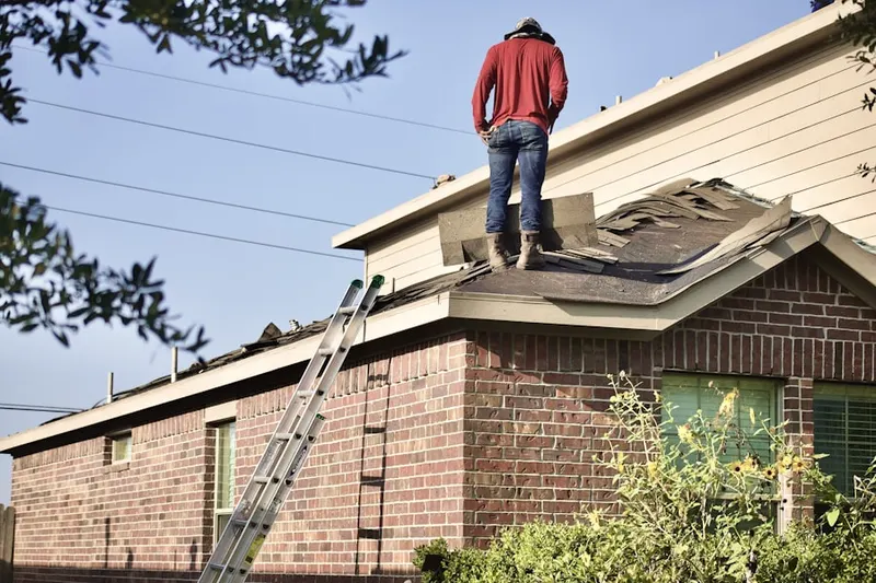 Professional roofer working on a residential roof in Oswego